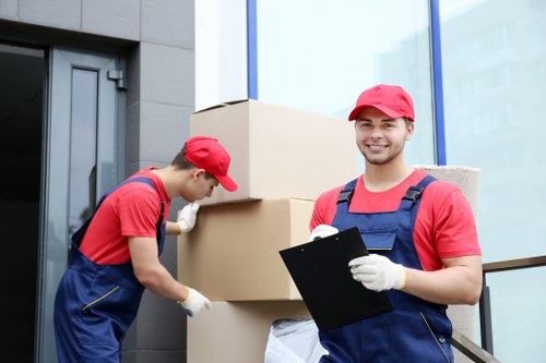 Careful unpacking of household items in a West Hampstead flat after moving