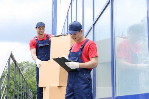 Mover wearing PPE while carrying furniture safely